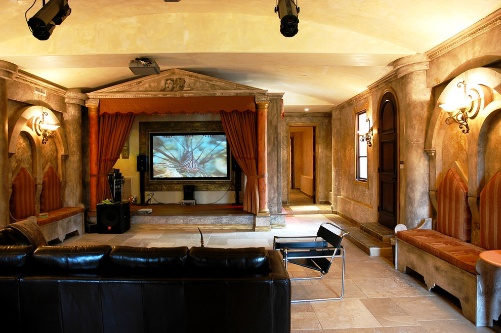 This is an example of an expansive mediterranean enclosed home cinema in Los Angeles with multi-coloured walls, limestone flooring, beige floors and a built-in media unit.