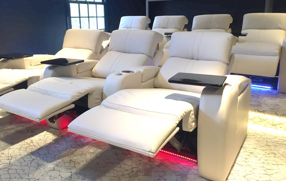 This is an example of a medium sized modern enclosed home cinema in Dallas with blue walls, carpet, a projector screen and beige floors.