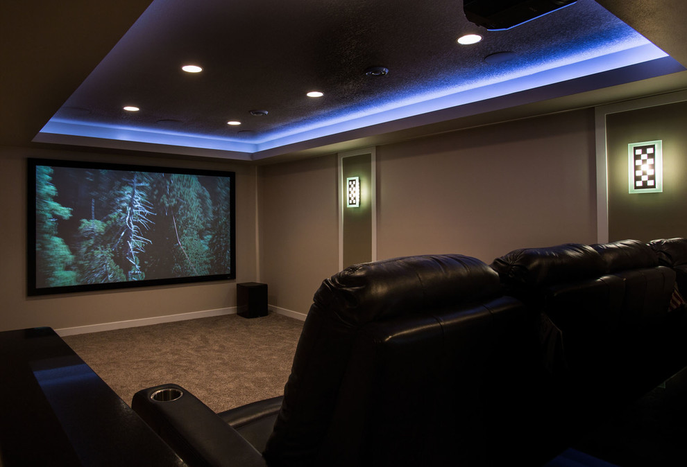 Modelo de cine en casa contemporáneo con paredes beige, moqueta y pantalla de proyección
