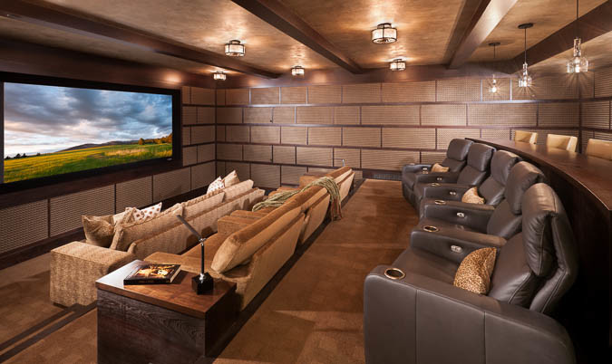 Home theater - large modern enclosed carpeted and brown floor home theater idea in Other with brown walls and a media wall