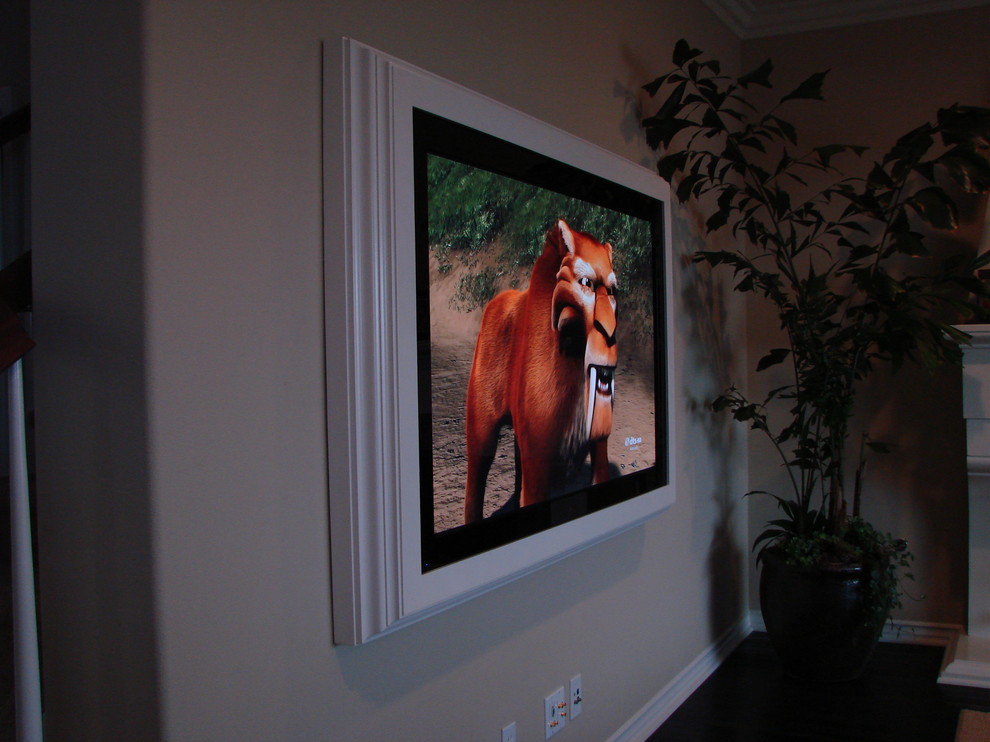 Example of a home theater design in Orange County with a wall-mounted tv