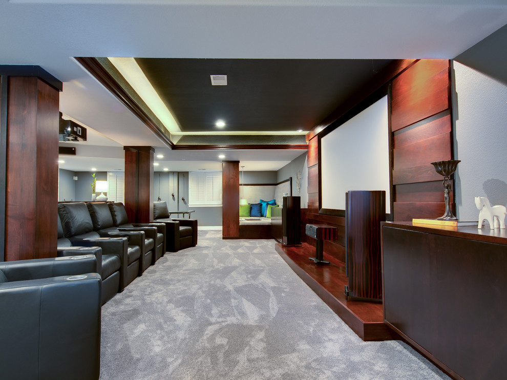 Home theater - huge contemporary carpeted and gray floor home theater idea in Denver with gray walls