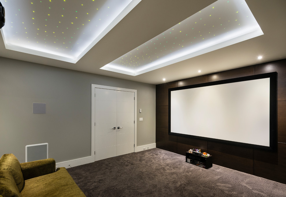Medium sized contemporary enclosed home cinema in Vancouver with grey walls, carpet, a projector screen and grey floors.