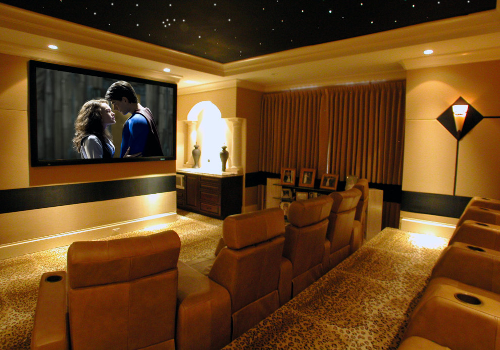 Large trendy enclosed carpeted and brown floor home theater photo in New Orleans with beige walls and a wall-mounted tv