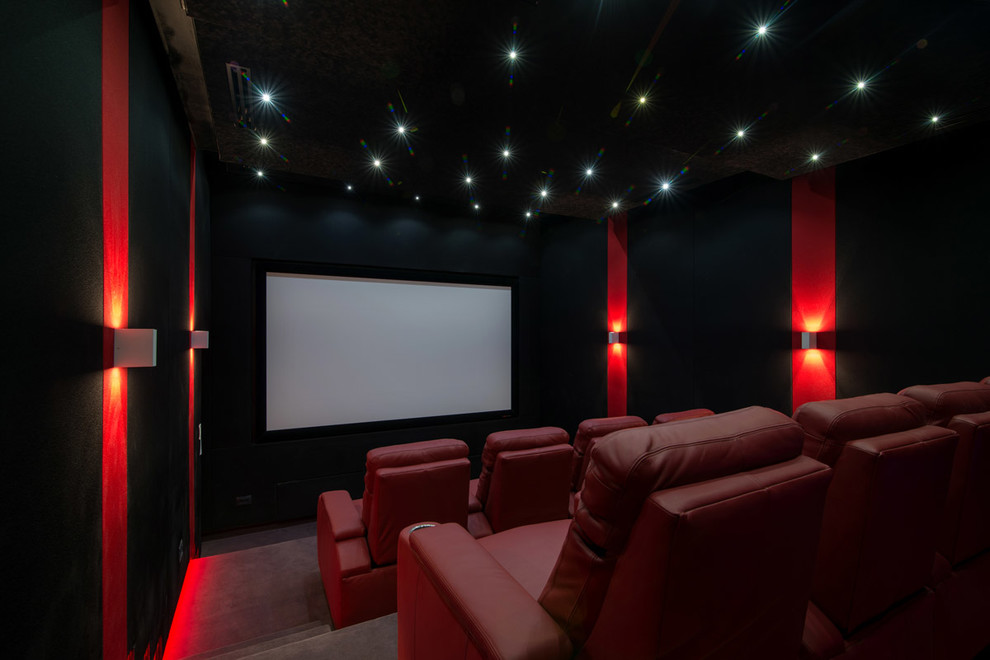 Photo of a large contemporary enclosed home cinema in Other with black walls, carpet and a projector screen.