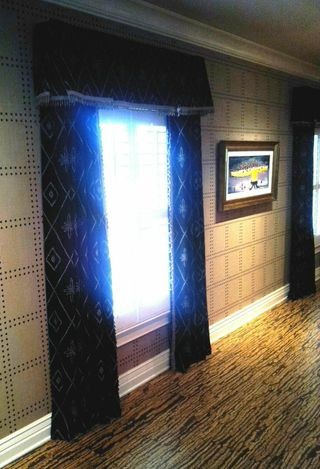 Transitional home theater photo in Indianapolis with beige walls and a media wall