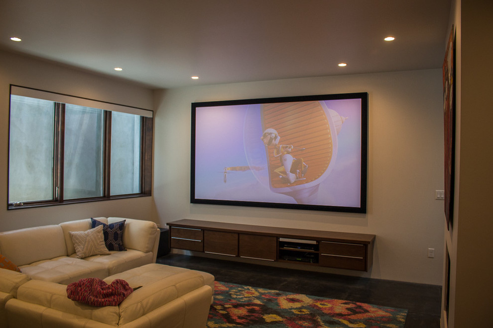 Design ideas for a medium sized modern open plan home cinema in Salt Lake City with white walls, concrete flooring and a projector screen.