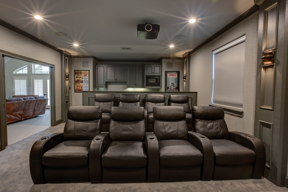 Example of a large classic enclosed carpeted home theater design in Houston with beige walls and a projector screen