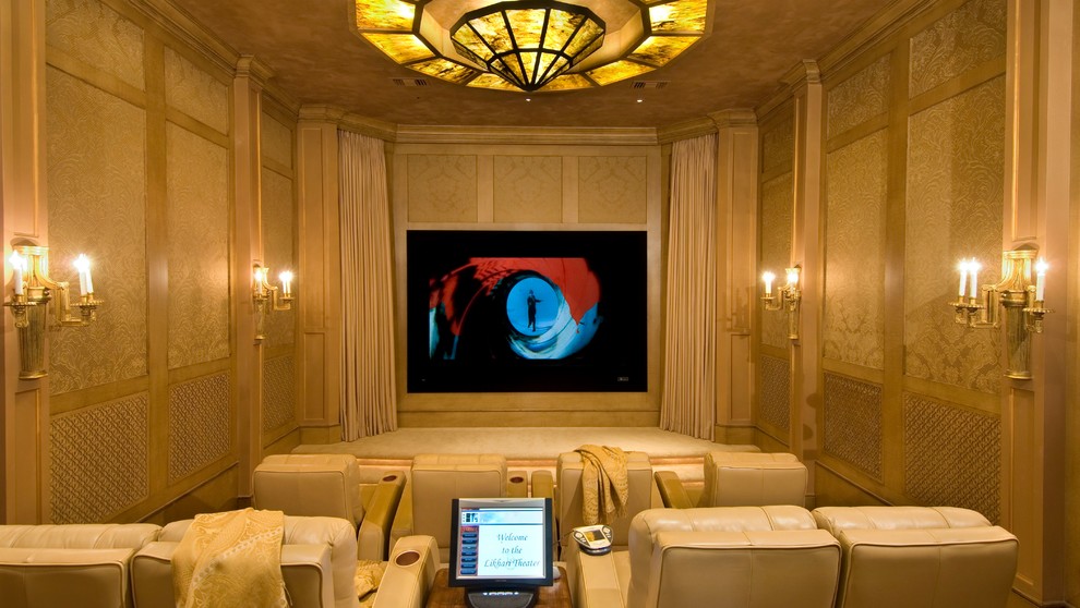 This is an example of a mediterranean enclosed home cinema in Houston with beige walls, carpet, a built-in media unit and beige floors.