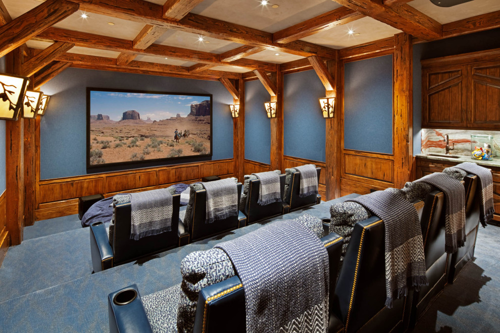 Стильный дизайн: изолированный домашний кинотеатр в стиле рустика с синими стенами, ковровым покрытием, проектором и синим полом - последний тренд