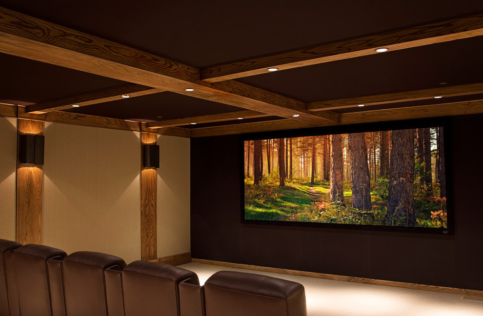 Large mountain style enclosed carpeted home theater photo in Los Angeles with beige walls and a projector screen