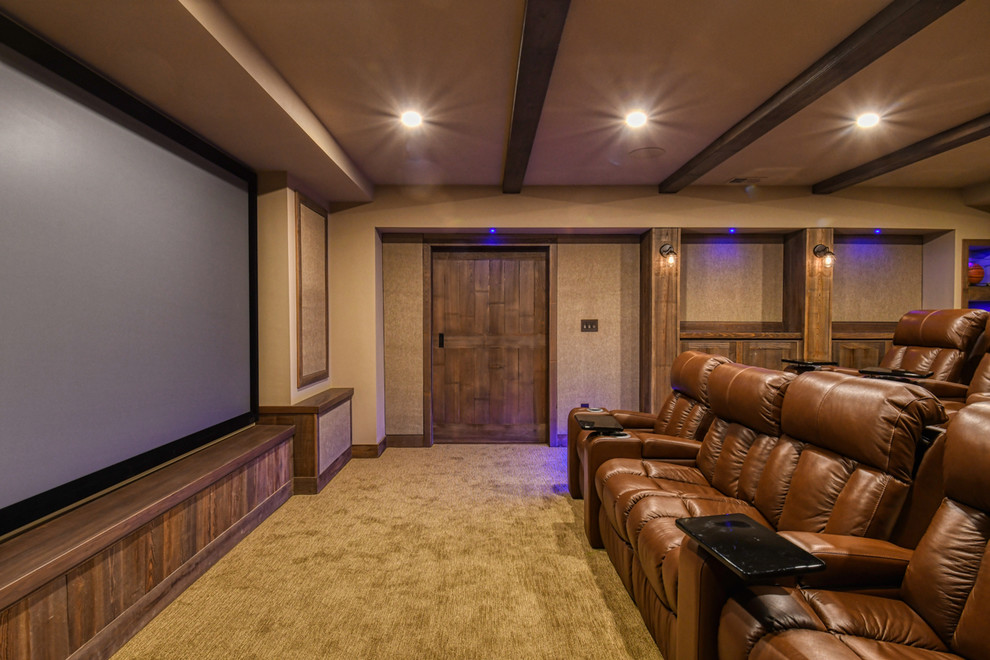 Idée de décoration pour une grande salle de cinéma chalet fermée avec un mur beige, moquette, un écran de projection et un sol beige.