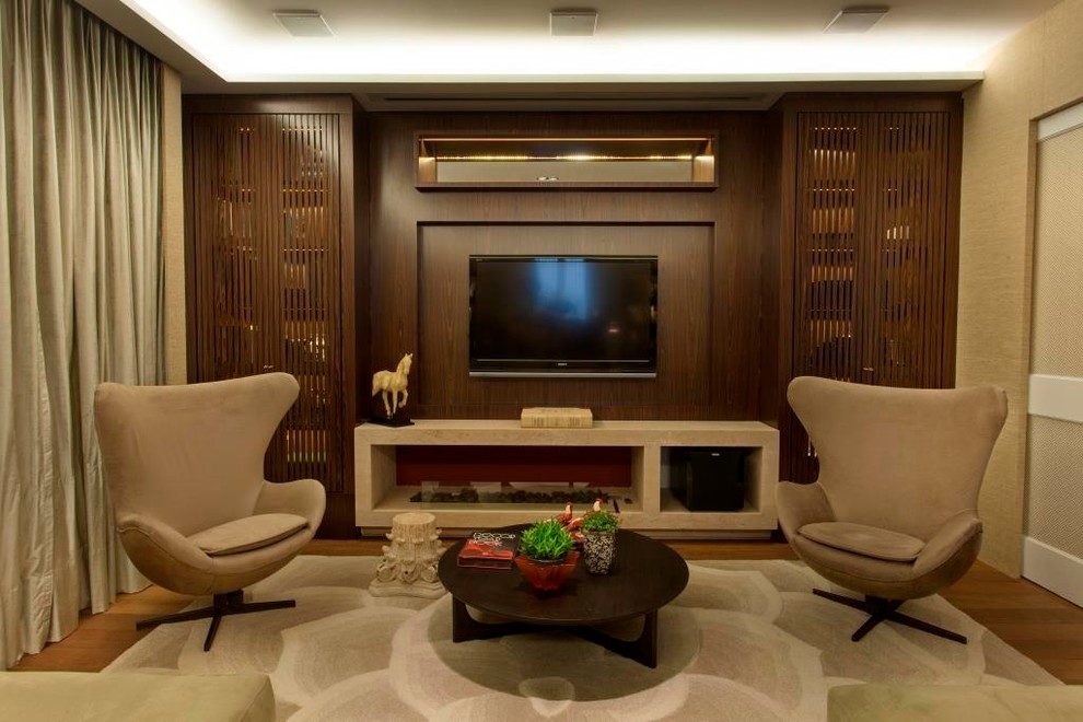 Inspiration for a mid-sized modern enclosed dark wood floor home theater remodel with beige walls and a projector screen