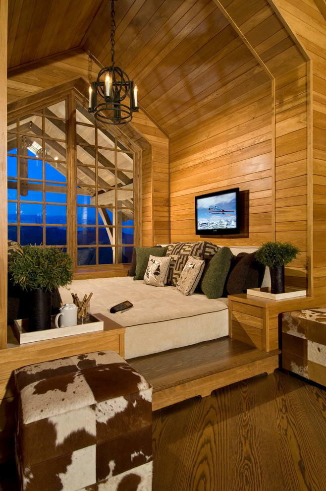 Photo of a rustic home cinema in New York with a wall mounted tv.