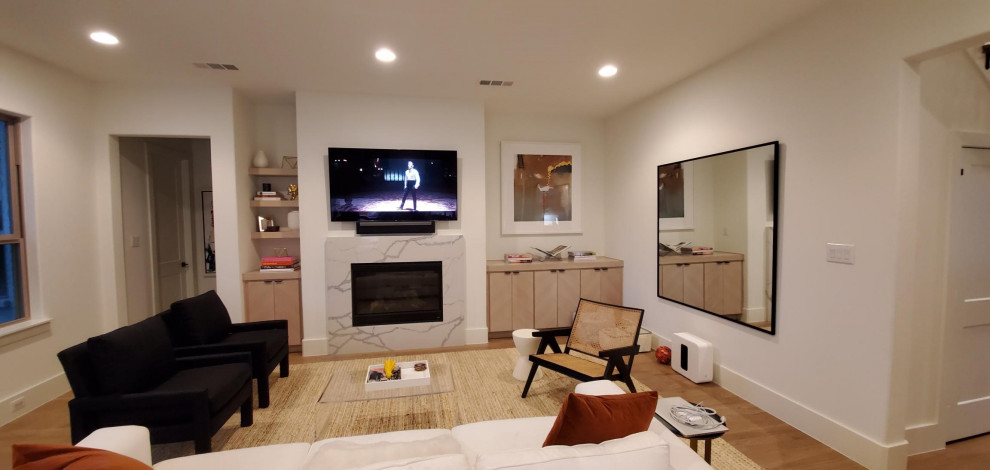 Home theater - modern home theater idea in Dallas with a wall-mounted tv