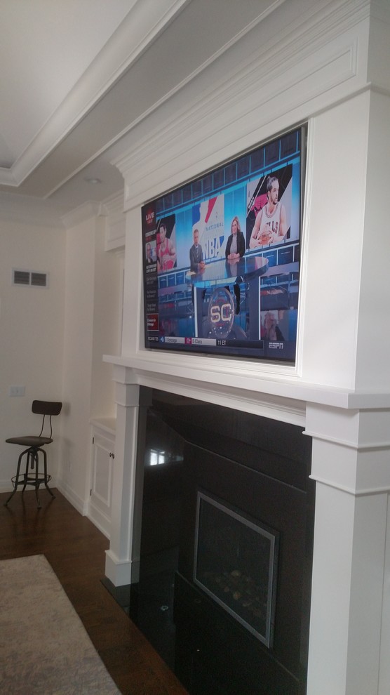 Photo of a large home cinema in Denver with white walls and a wall mounted tv.