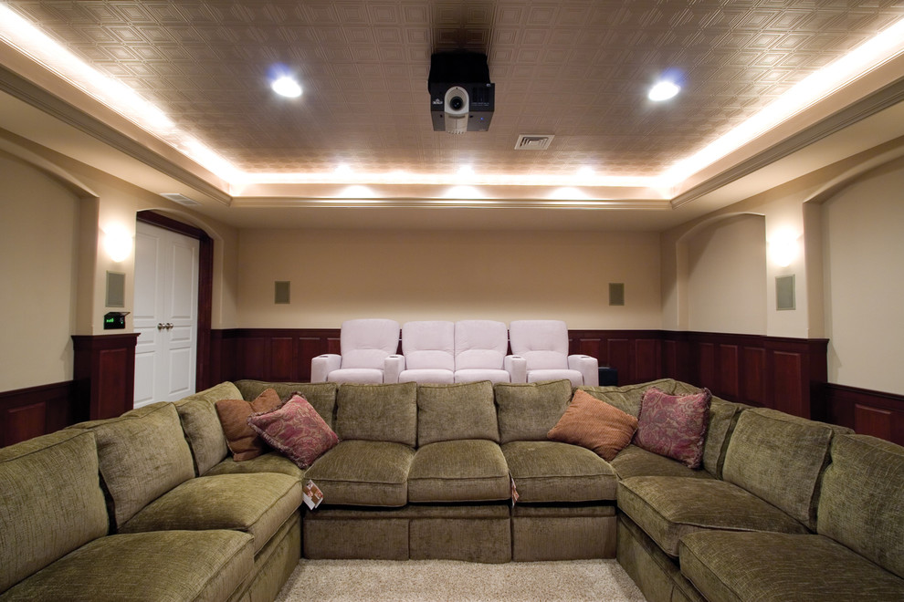 Inspiration for a huge timeless enclosed carpeted home theater remodel in Other with beige walls and a projector screen