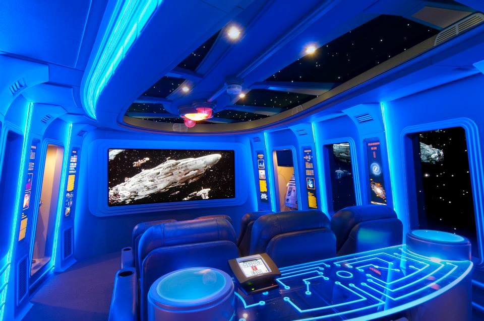 Home theater - large modern enclosed carpeted home theater idea in San Diego with blue walls and a projector screen