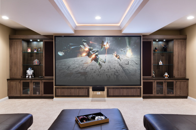 Inspiration for a large enclosed home cinema in Chicago with beige walls, carpet, a projector screen and beige floors.