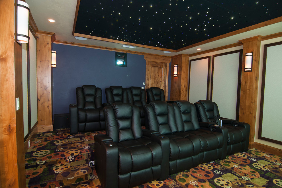 Photo of a large rustic enclosed home cinema in Denver with blue walls, carpet and a built-in media unit.
