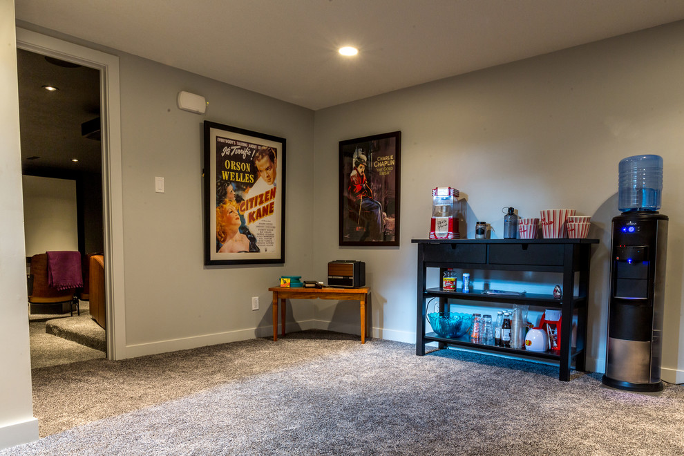 Example of a mid-sized classic enclosed carpeted and gray floor home theater design in Calgary with gray walls and a projector screen