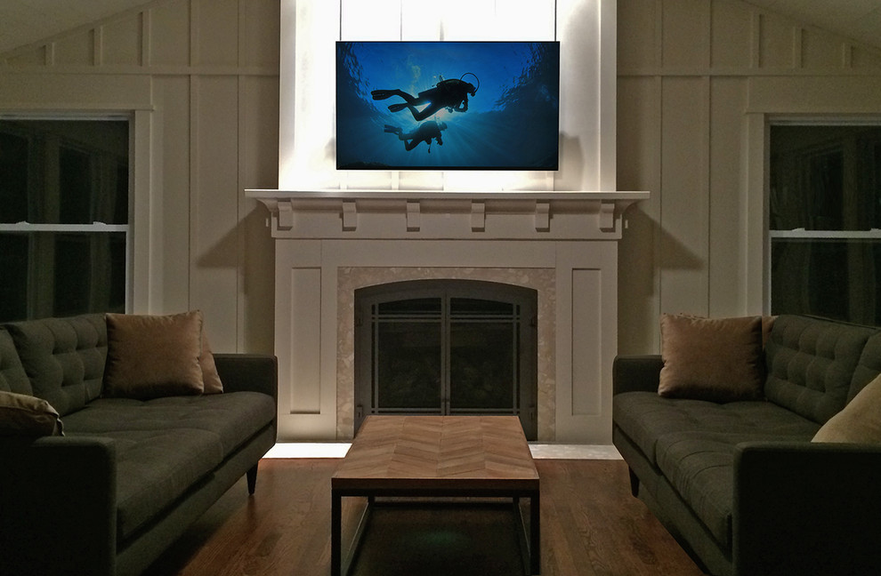 Example of a mid-sized beach style enclosed dark wood floor home theater design in Chicago with white walls and a wall-mounted tv
