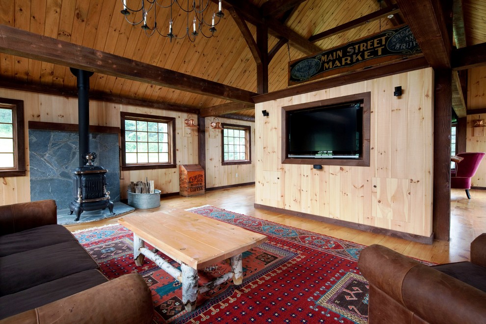 Inspiration for a large timeless open concept light wood floor home theater remodel in Manchester with a media wall