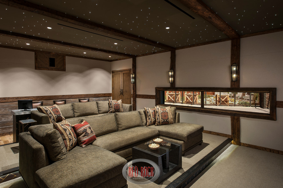 Photo of an expansive rustic enclosed home cinema in Phoenix with carpet, a projector screen and grey walls.