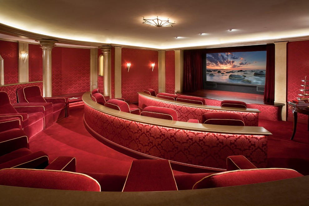 Ejemplo de cine en casa cerrado tradicional grande con paredes rojas, moqueta, pantalla de proyección y suelo rojo