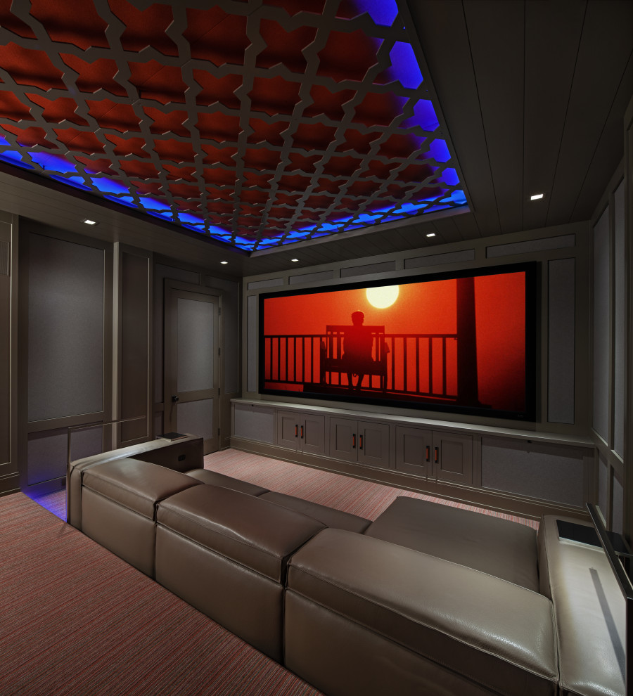 На фото: домашний кинотеатр с серыми стенами, ковровым покрытием, проектором и разноцветным полом