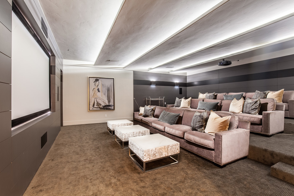 Design ideas for an expansive traditional enclosed home cinema in Las Vegas with multi-coloured walls, carpet, a projector screen and brown floors.