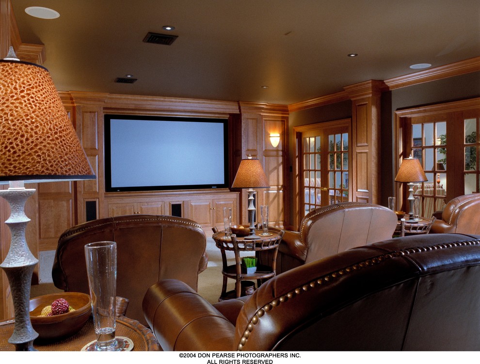 Inspiration for a timeless enclosed carpeted home theater remodel in Philadelphia with brown walls and a media wall