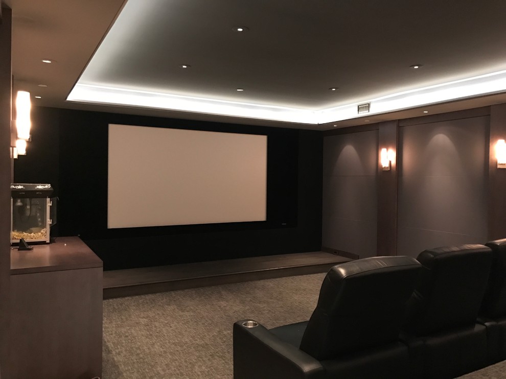 Medium sized traditional enclosed home cinema in San Francisco with brown walls, carpet, a projector screen and grey floors.