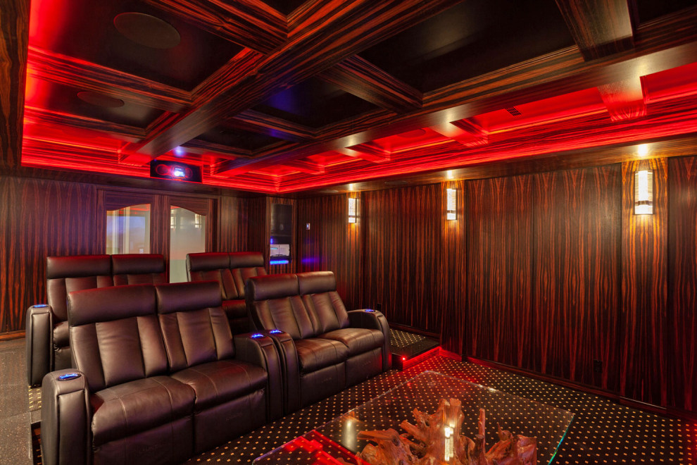 Diseño de cine en casa cerrado de estilo americano grande con paredes marrones, moqueta, pantalla de proyección y suelo negro
