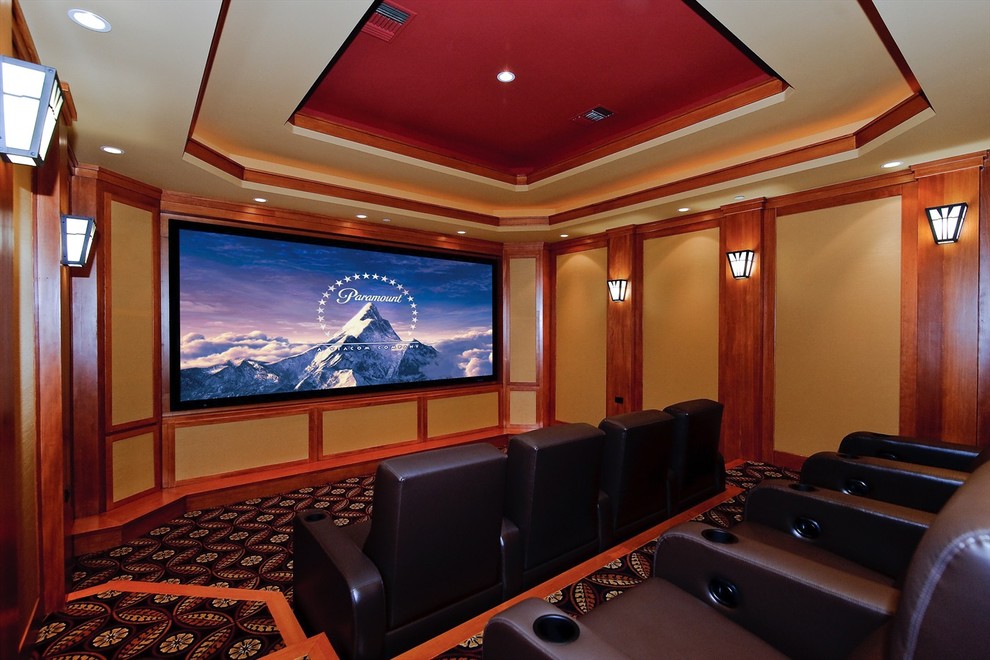 Large arts and crafts enclosed carpeted home theater photo in Orange County with a projector screen and beige walls