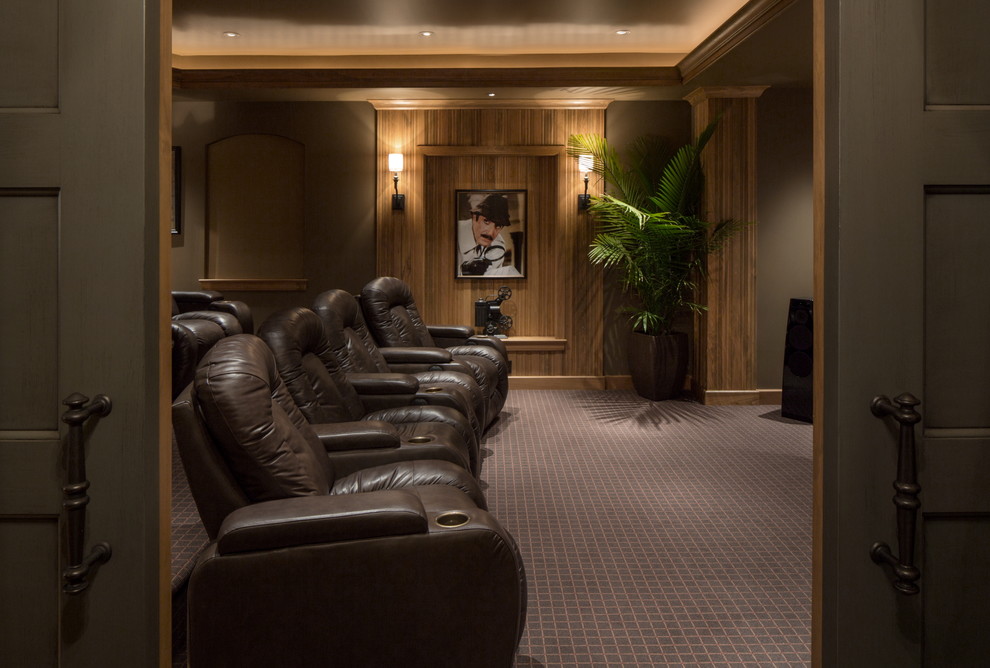 This is an example of an expansive classic enclosed home cinema in Omaha with brown walls, carpet and a projector screen.