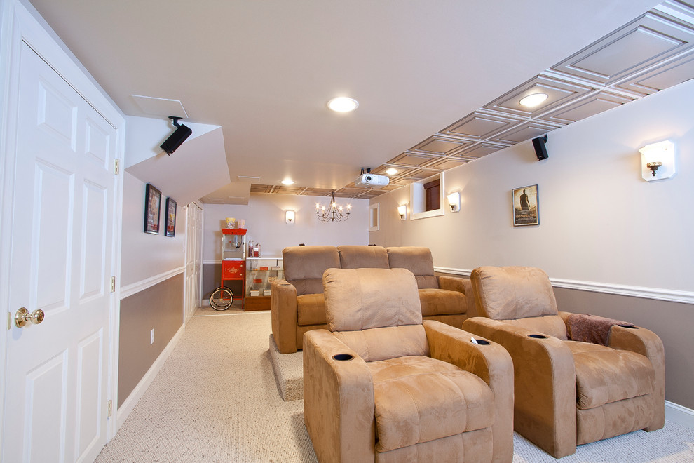 This is an example of a medium sized classic enclosed home cinema in Newark with multi-coloured walls, carpet, a projector screen and beige floors.