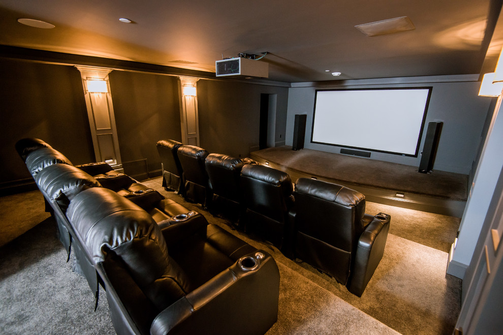 This is an example of a large contemporary enclosed home cinema in Vancouver with grey walls, carpet and a projector screen.