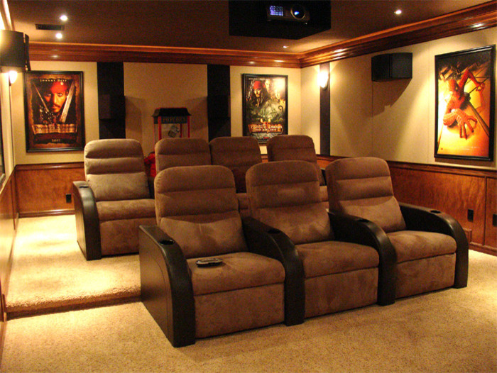 Inspiration for a large traditional enclosed home cinema in Other with beige walls, carpet, a projector screen and beige floors.