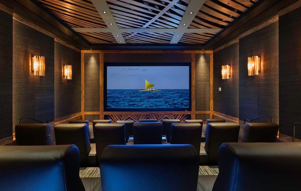 Example of a large island style enclosed carpeted home theater design in Hawaii with brown walls and a projector screen