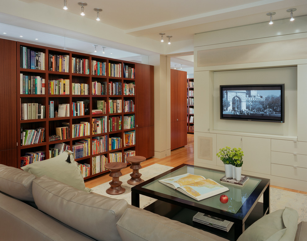 Inspiration for a contemporary open plan home cinema in New York with white walls, light hardwood flooring and a wall mounted tv.