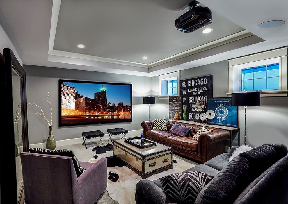 This is an example of a medium sized bohemian enclosed home cinema in Chicago with grey walls, carpet, a projector screen and grey floors.