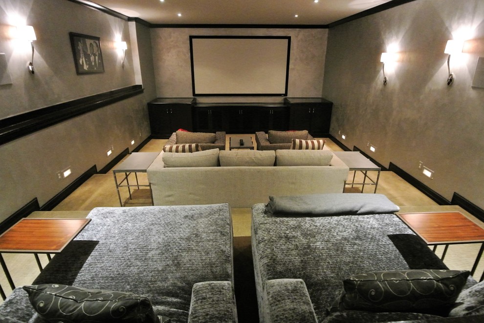 Example of a large transitional enclosed carpeted home theater design in Indianapolis with gray walls and a media wall