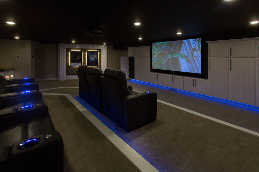 Photo of a large modern enclosed home cinema in Other with beige walls, carpet and a projector screen.