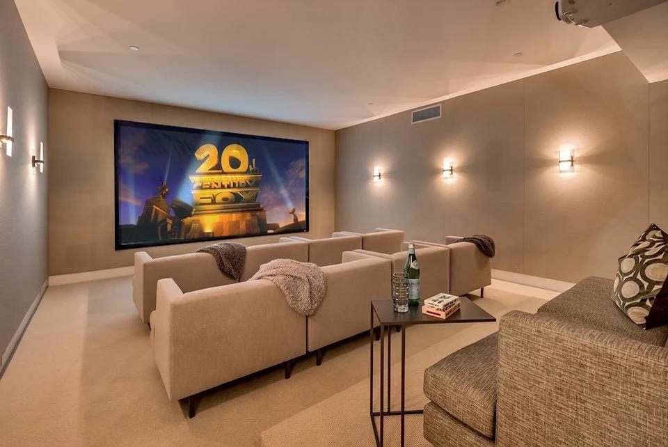Inspiration for a large modern enclosed carpeted and beige floor home theater remodel in San Francisco with beige walls and a projector screen