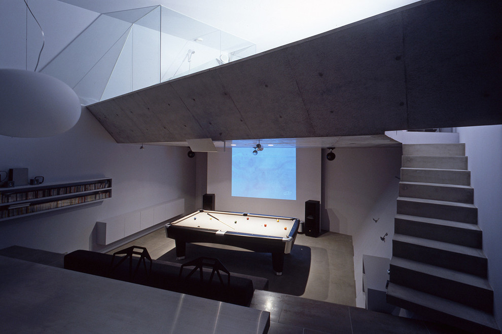 Medium sized industrial open plan home cinema in Kyoto with concrete flooring, a projector screen and grey floors.