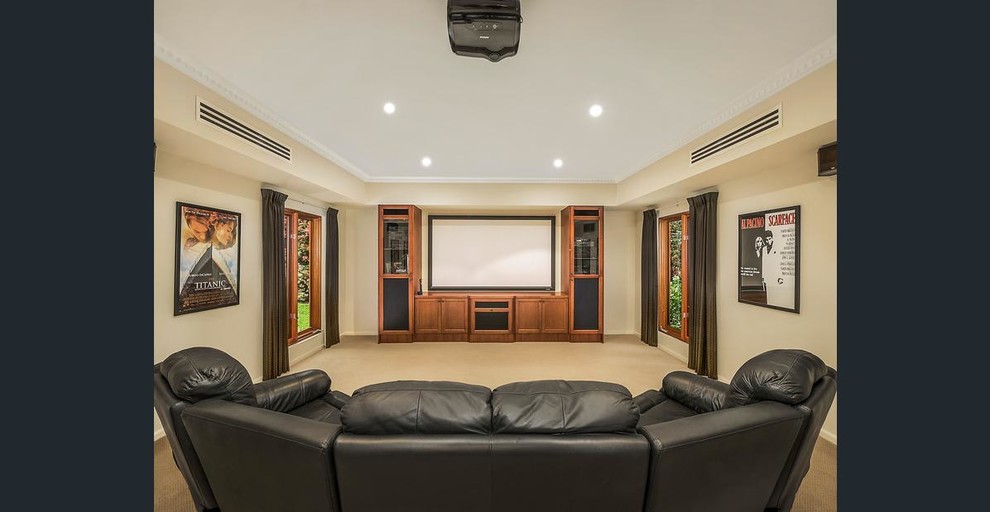 Home theater - large contemporary enclosed carpeted home theater idea in Melbourne with a projector screen