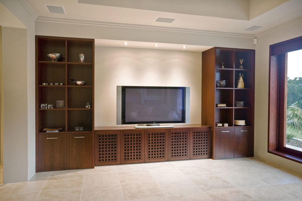 Large modern enclosed home cinema in Sydney with beige walls and travertine flooring.
