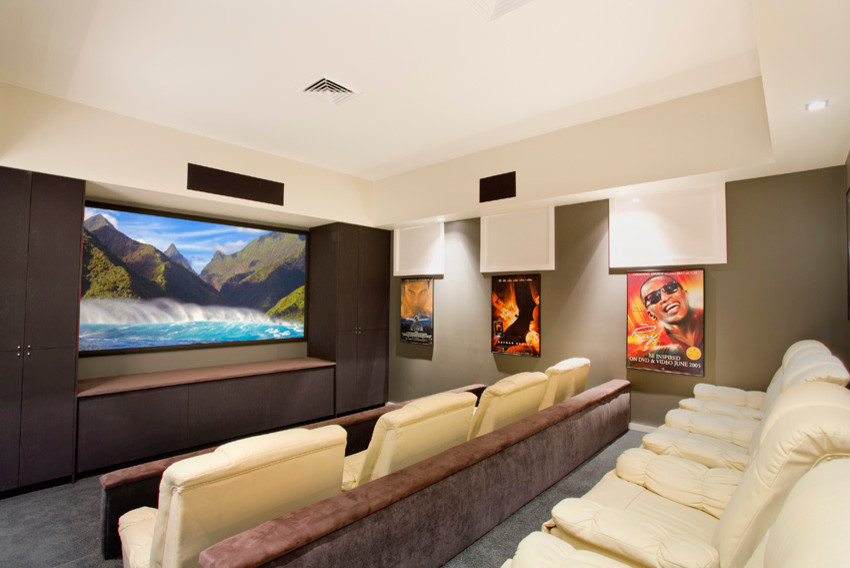 Expansive rural open plan home cinema in Sydney with carpet, a wall mounted tv, brown walls and black floors.