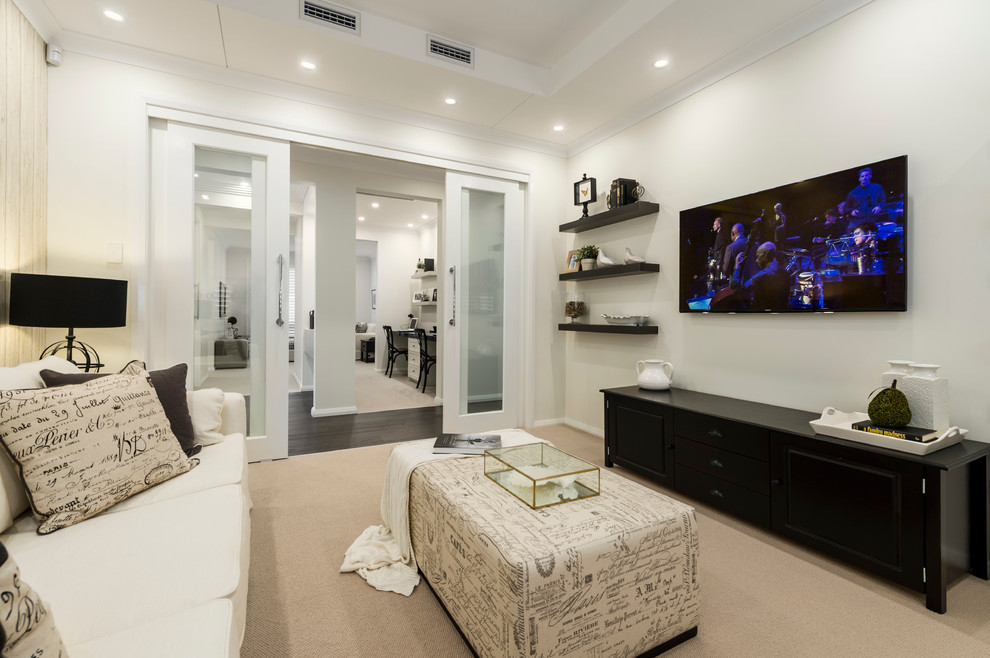 Mid-sized trendy enclosed home theater photo in Sydney with beige walls and a wall-mounted tv